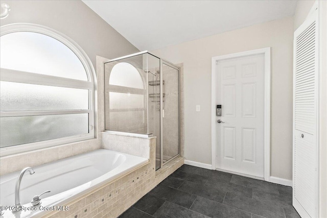 bathroom featuring plus walk in shower and tile patterned floors