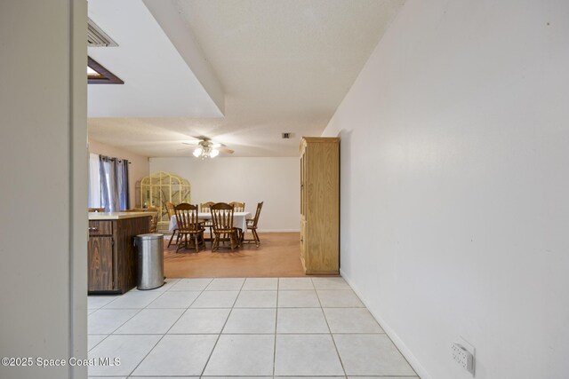 interior space with ceiling fan