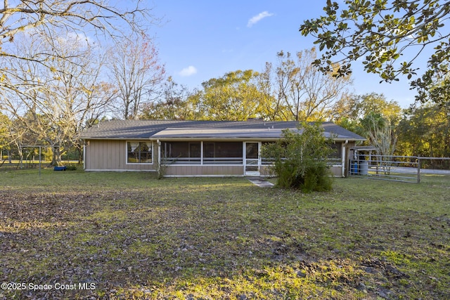 view of front of house with a sunroom and a front yard