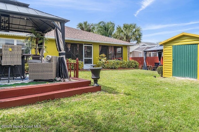 view of yard featuring a gazebo and a shed