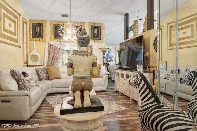 living area with an inviting chandelier and dark wood-type flooring