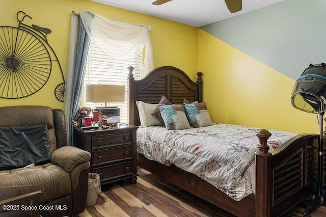 bedroom featuring ceiling fan and dark hardwood / wood-style floors