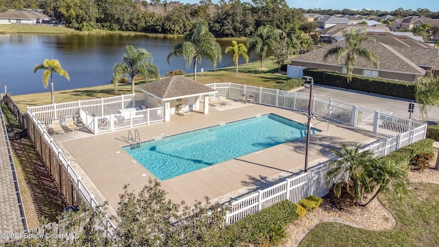 view of pool with a water view and a patio area