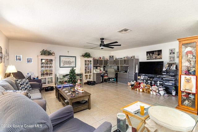 tiled living room featuring ceiling fan and a textured ceiling