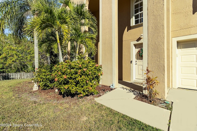 entrance to property with a lawn