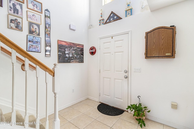 tiled foyer with a high ceiling