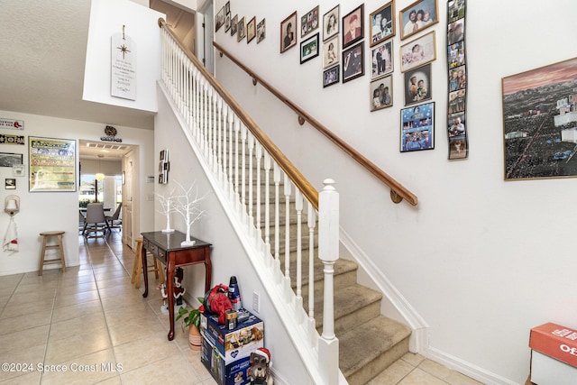 staircase featuring tile patterned floors