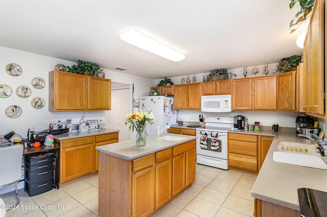 kitchen featuring light tile patterned flooring, a kitchen island, sink, and white appliances