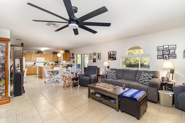 tiled living room with ceiling fan