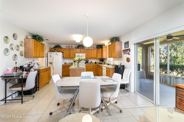 dining room featuring sink, light tile patterned floors, and ceiling fan