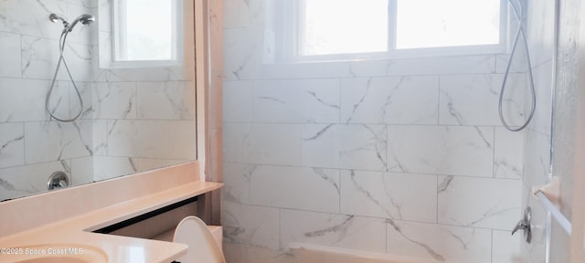 bathroom with vanity, a tile shower, and toilet