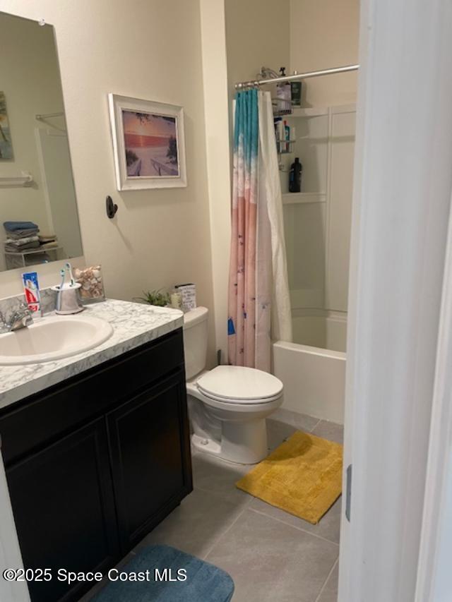 full bathroom with vanity, tile patterned floors, toilet, and shower / bath combo