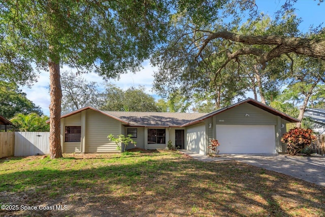 single story home with a garage and a front lawn