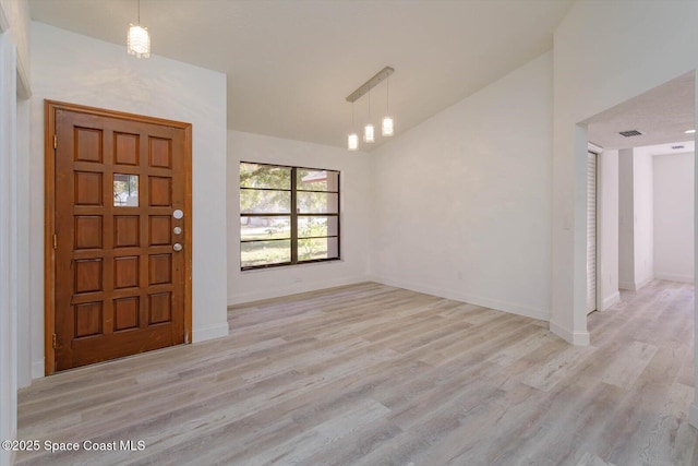 entryway with lofted ceiling and light hardwood / wood-style floors