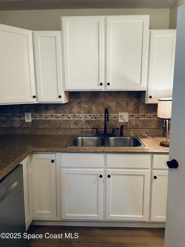 kitchen featuring sink, backsplash, stainless steel dishwasher, and white cabinets