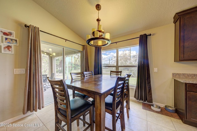 dining space with lofted ceiling, a textured ceiling, and light tile patterned flooring