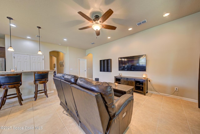 tiled living room with ceiling fan