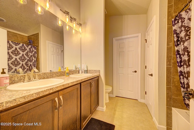 bathroom featuring vanity, a textured ceiling, curtained shower, tile patterned floors, and toilet