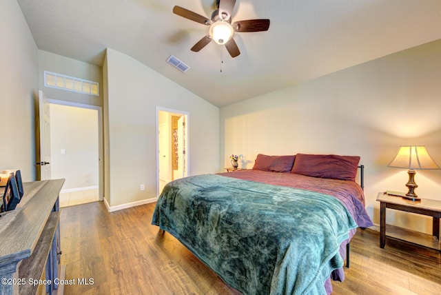 bedroom with hardwood / wood-style flooring, vaulted ceiling, and ceiling fan