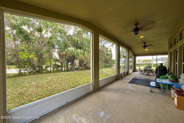 sunroom featuring vaulted ceiling and ceiling fan