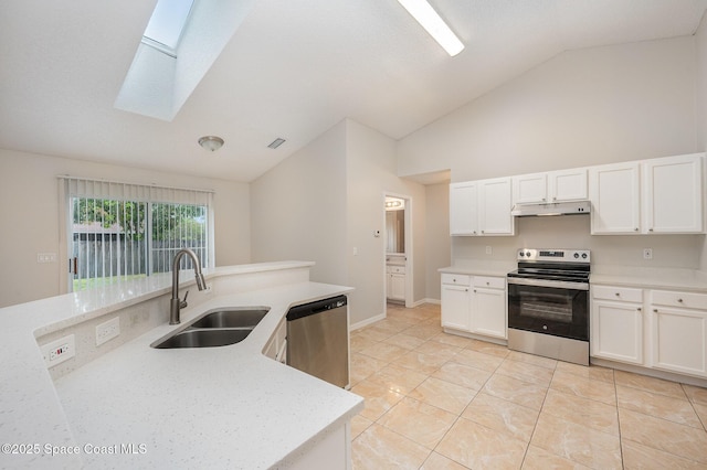 kitchen featuring sink, a skylight, light tile patterned floors, stainless steel appliances, and white cabinets