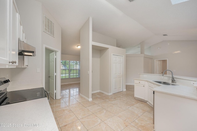 kitchen featuring sink, light tile patterned floors, white cabinets, stainless steel electric range oven, and vaulted ceiling