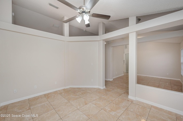 unfurnished room with a textured ceiling, vaulted ceiling, tile patterned floors, and ceiling fan