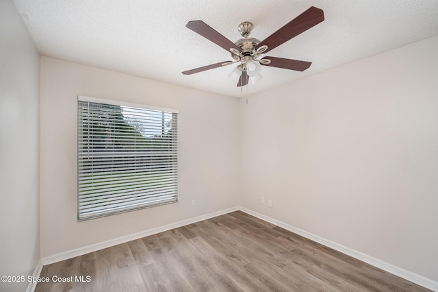 spare room featuring ceiling fan, a textured ceiling, and light wood-type flooring