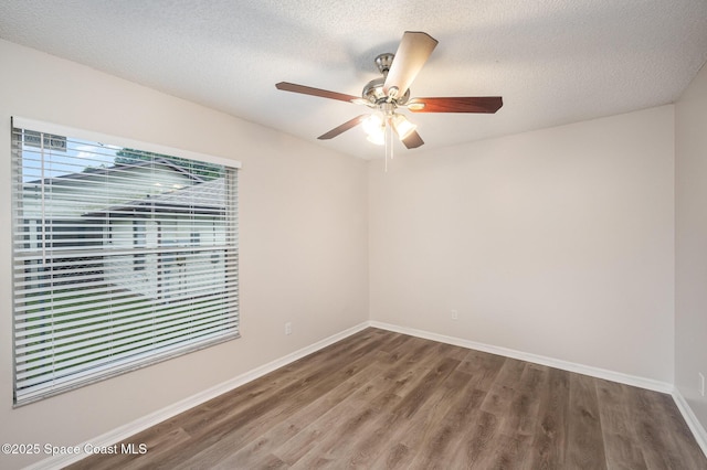 unfurnished room featuring ceiling fan, wood-type flooring, and a textured ceiling