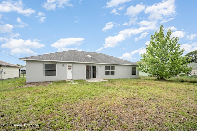 rear view of property with a yard