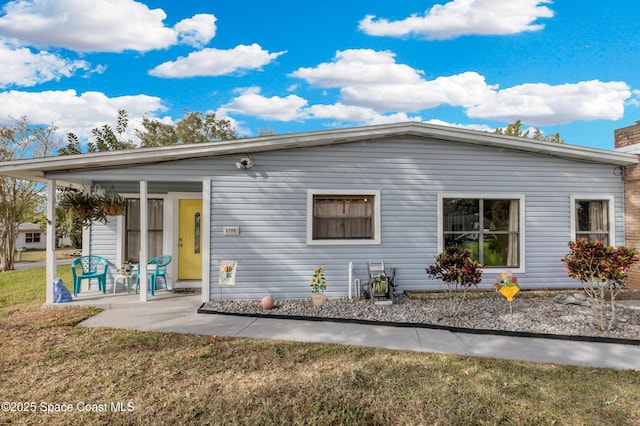 rear view of property with a yard