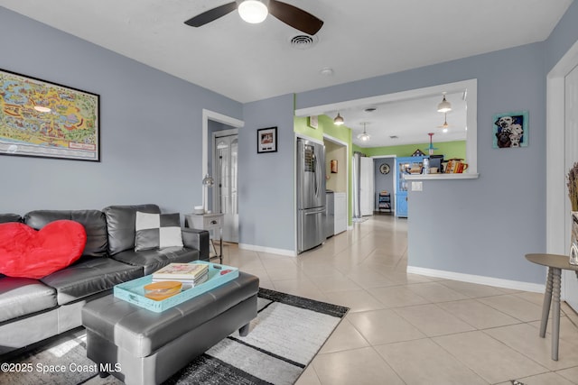 tiled living room with ceiling fan