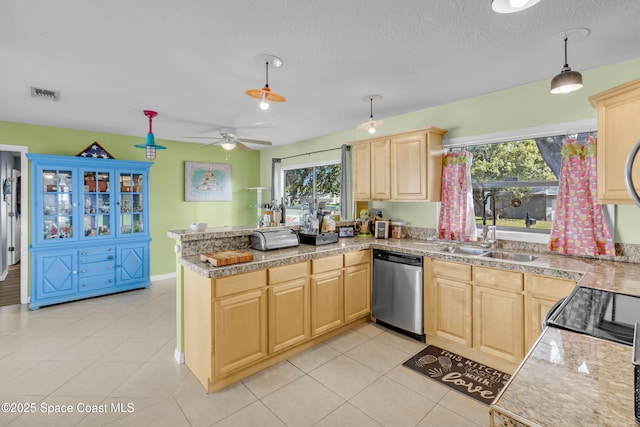 kitchen featuring dishwasher, sink, hanging light fixtures, and light brown cabinets