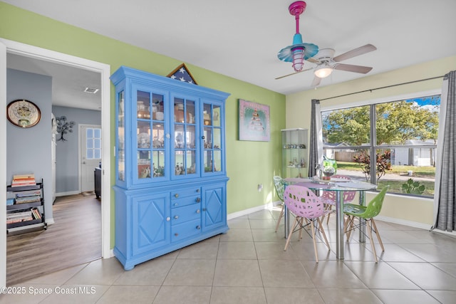 dining space featuring light tile patterned flooring and ceiling fan