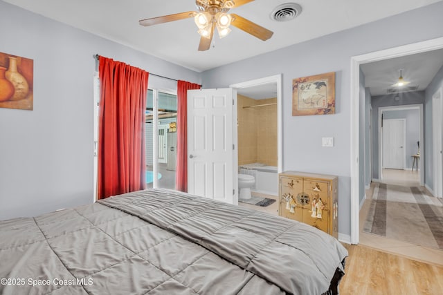 bedroom with light wood-type flooring and ensuite bath