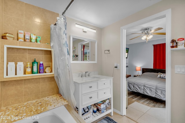 bathroom featuring ceiling fan, tile patterned floors, vanity, and shower / bath combo