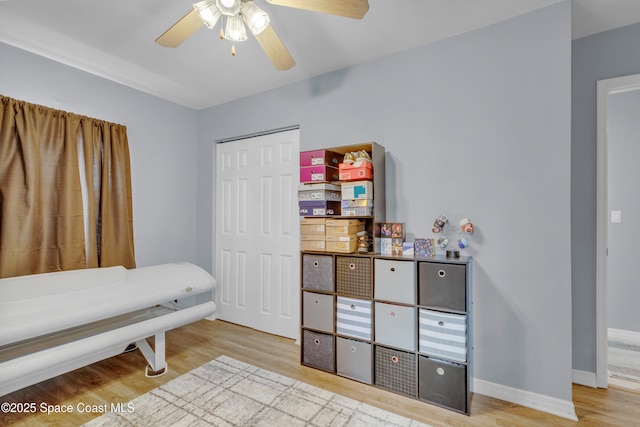 bedroom with a closet, ceiling fan, and light hardwood / wood-style flooring