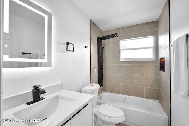 full bathroom featuring vanity, tiled shower / bath combo, and toilet