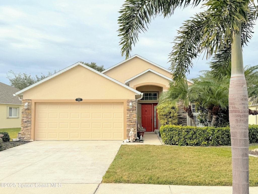 view of front of house featuring a garage and a front lawn