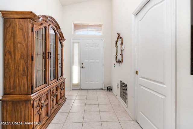 foyer entrance with visible vents, baseboards, and light tile patterned flooring