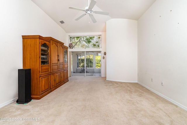 unfurnished room featuring visible vents, high vaulted ceiling, baseboards, light colored carpet, and ceiling fan