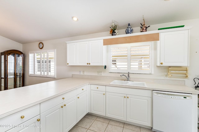 kitchen with a sink, white cabinetry, light countertops, light tile patterned floors, and dishwasher