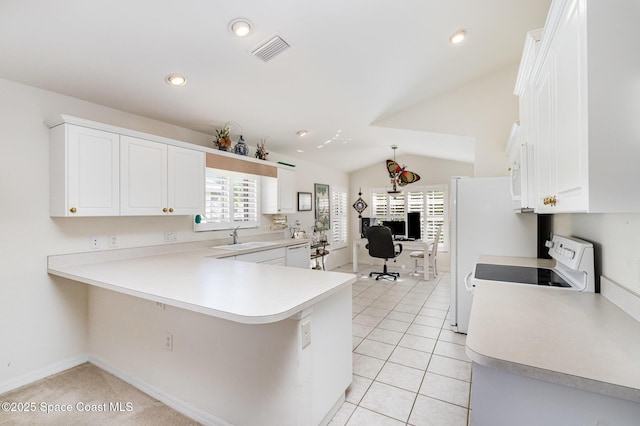 kitchen featuring visible vents, vaulted ceiling, light tile patterned floors, white appliances, and a sink