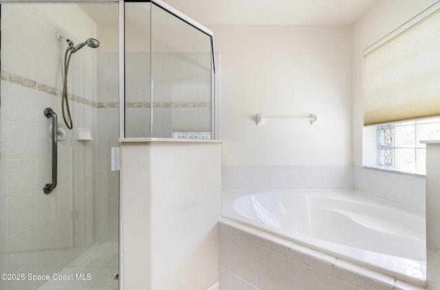 full bathroom featuring a shower stall and a garden tub