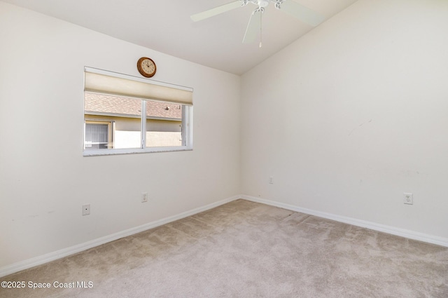 carpeted empty room with baseboards, lofted ceiling, and ceiling fan