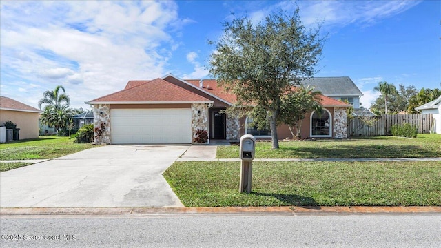 view of front of house featuring a garage and a front lawn