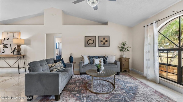 living room featuring ceiling fan, lofted ceiling, and a textured ceiling