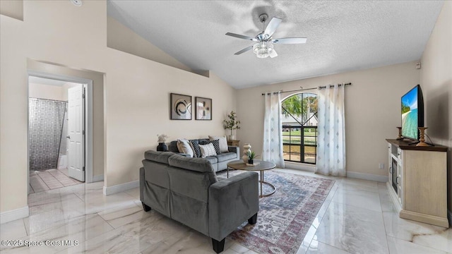 living room with ceiling fan, vaulted ceiling, and a textured ceiling