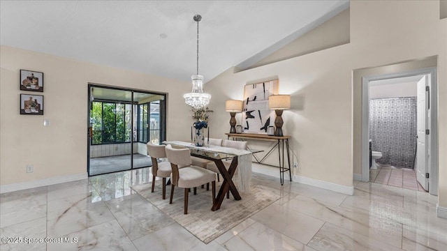 dining room with lofted ceiling and a notable chandelier