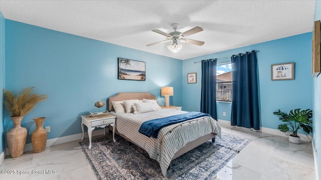 bedroom featuring ceiling fan and a textured ceiling